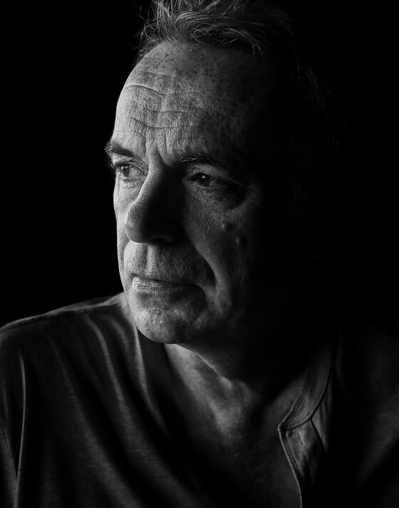 John Gill, a black and white portrait, looking away from the camera